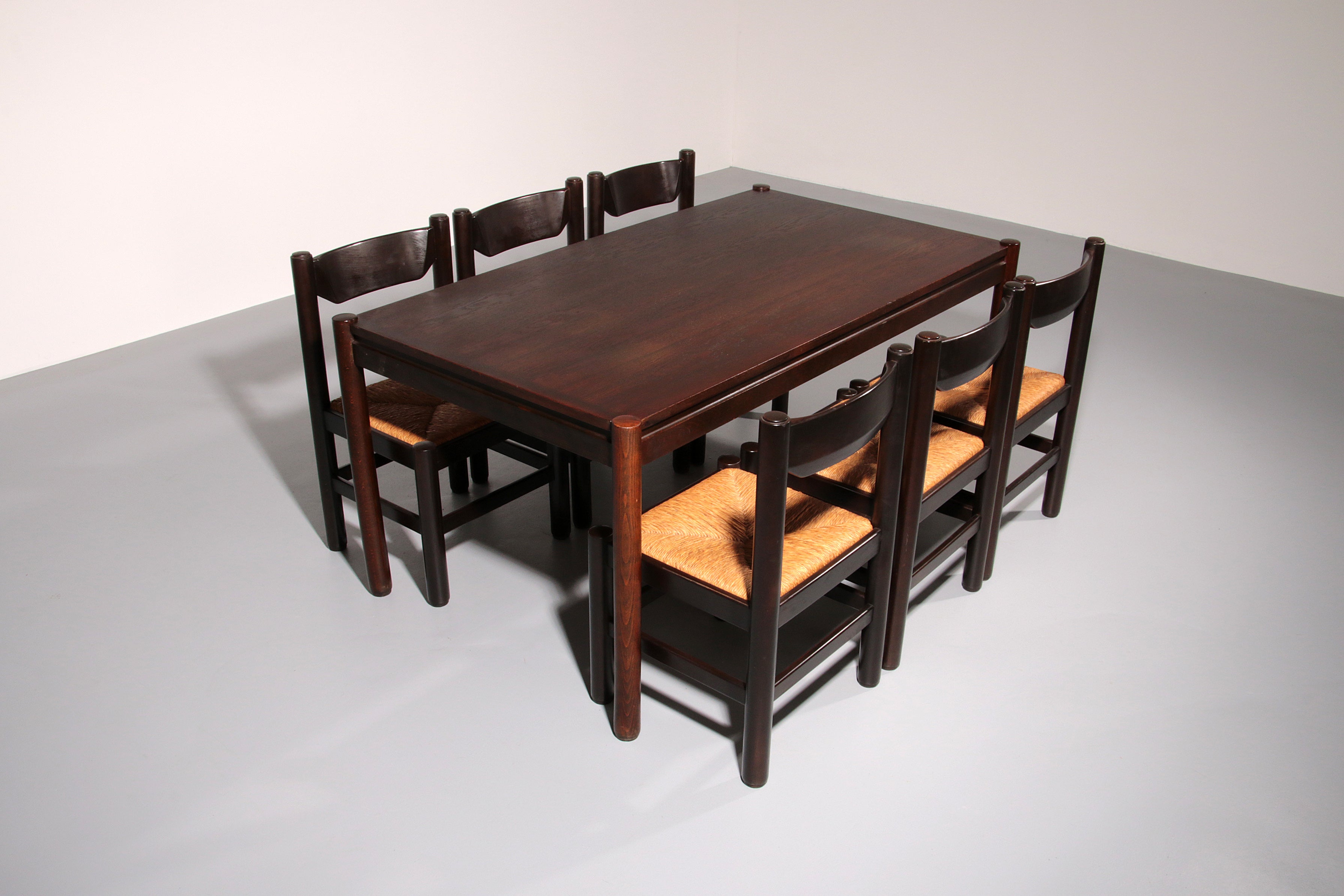 Dining Set inspired by Vico Magistretti, featuring six elegantly re-caned chairs and table.
