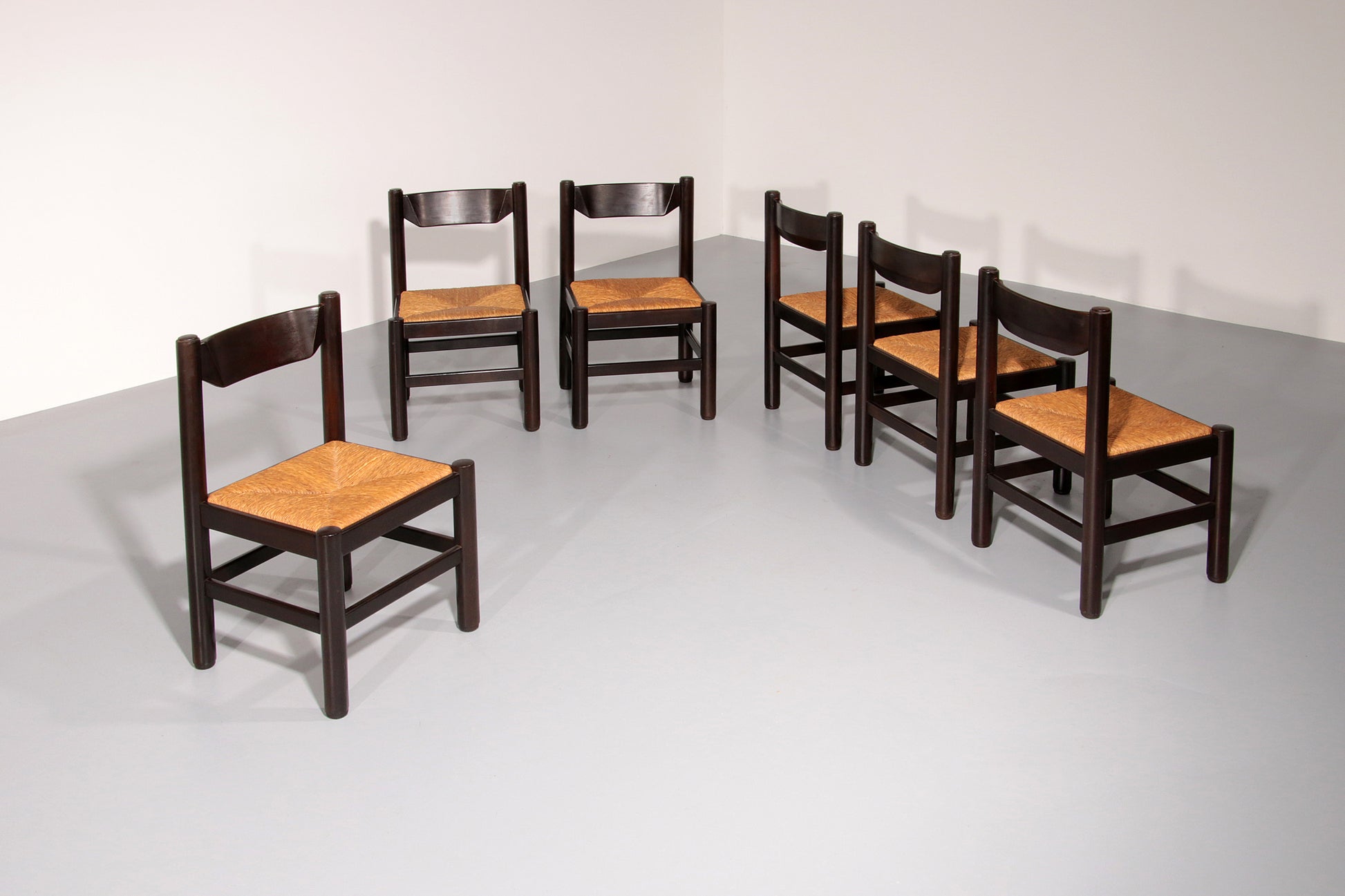 Dining Set inspired by Vico Magistretti, featuring six elegantly re-caned chairs and table.