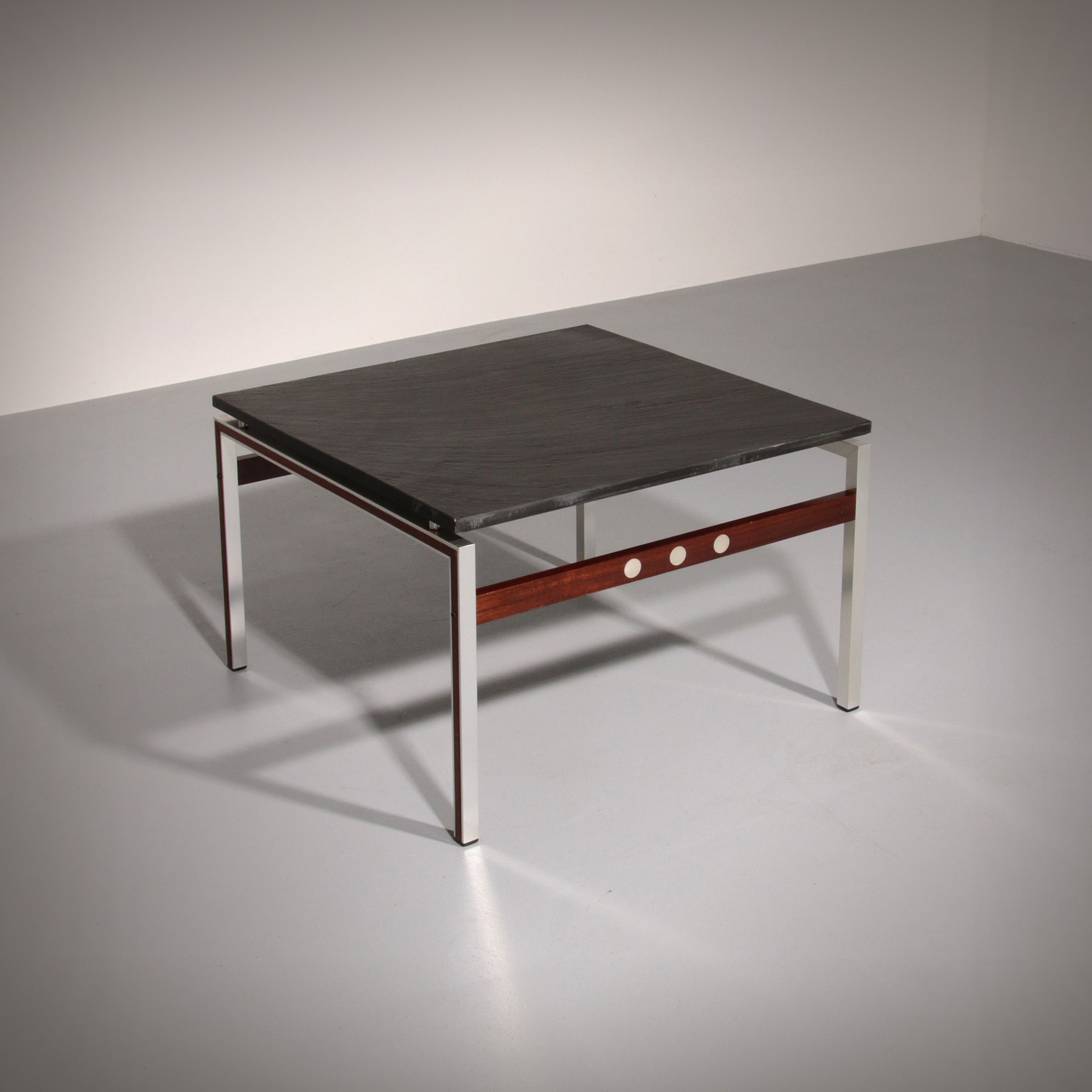 A beautiful and distinctive vintage coffee table, crafted in Denmark in the 1970s. The table combines a natural slate tabletop