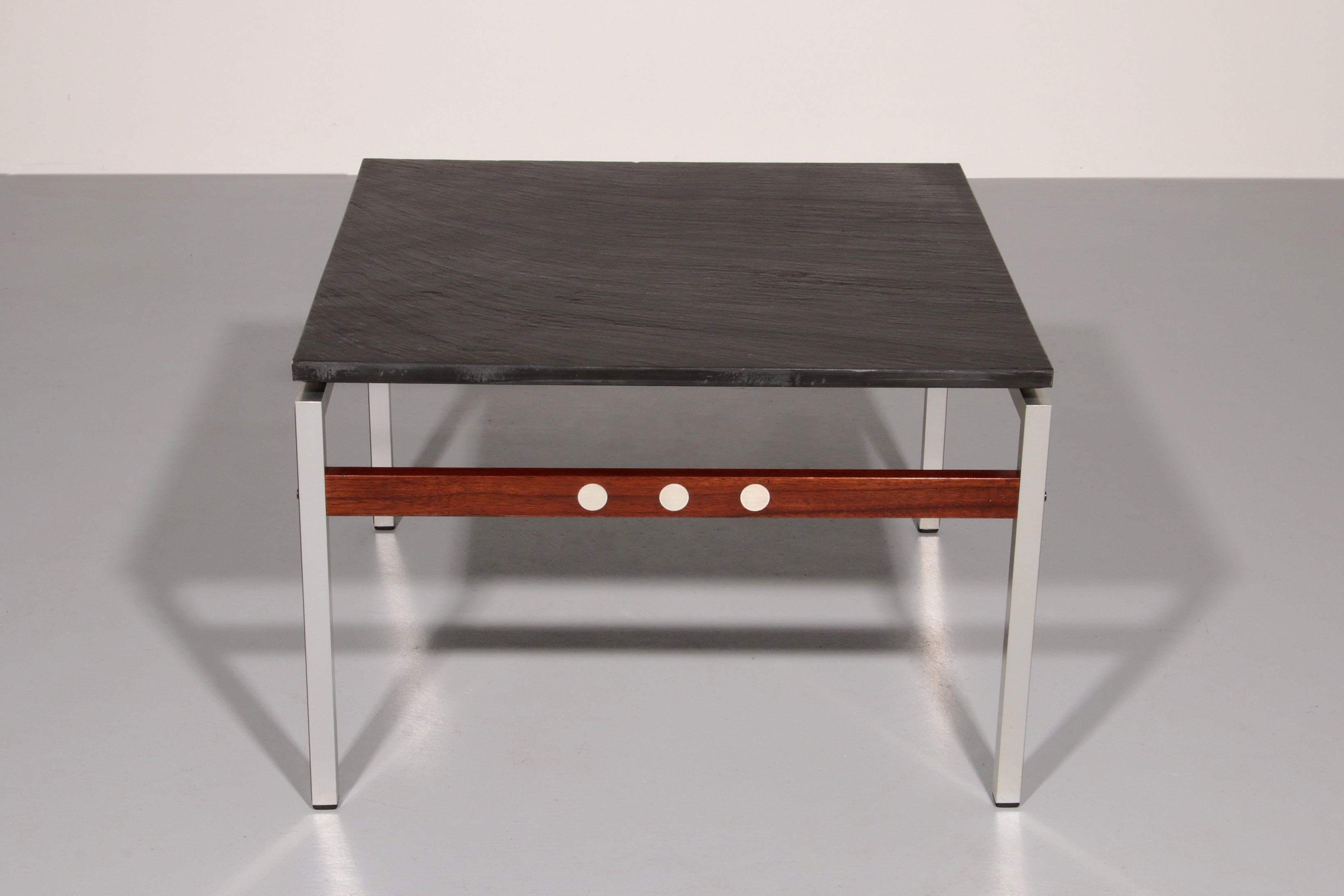 A beautiful and distinctive vintage coffee table, crafted in Denmark in the 1970s. The table combines a natural slate tabletop