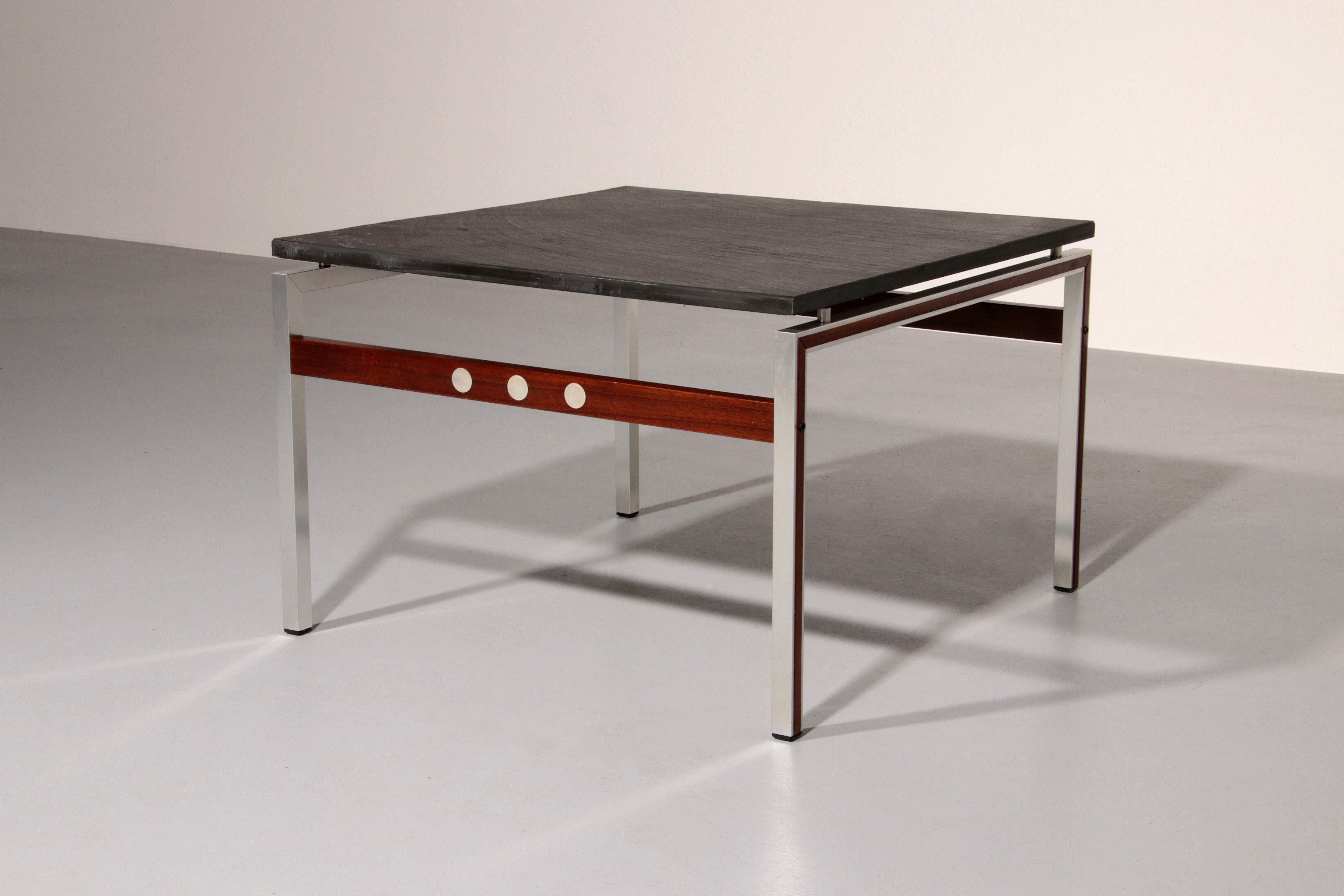 A beautiful and distinctive vintage coffee table, crafted in Denmark in the 1970s. The table combines a natural slate tabletop