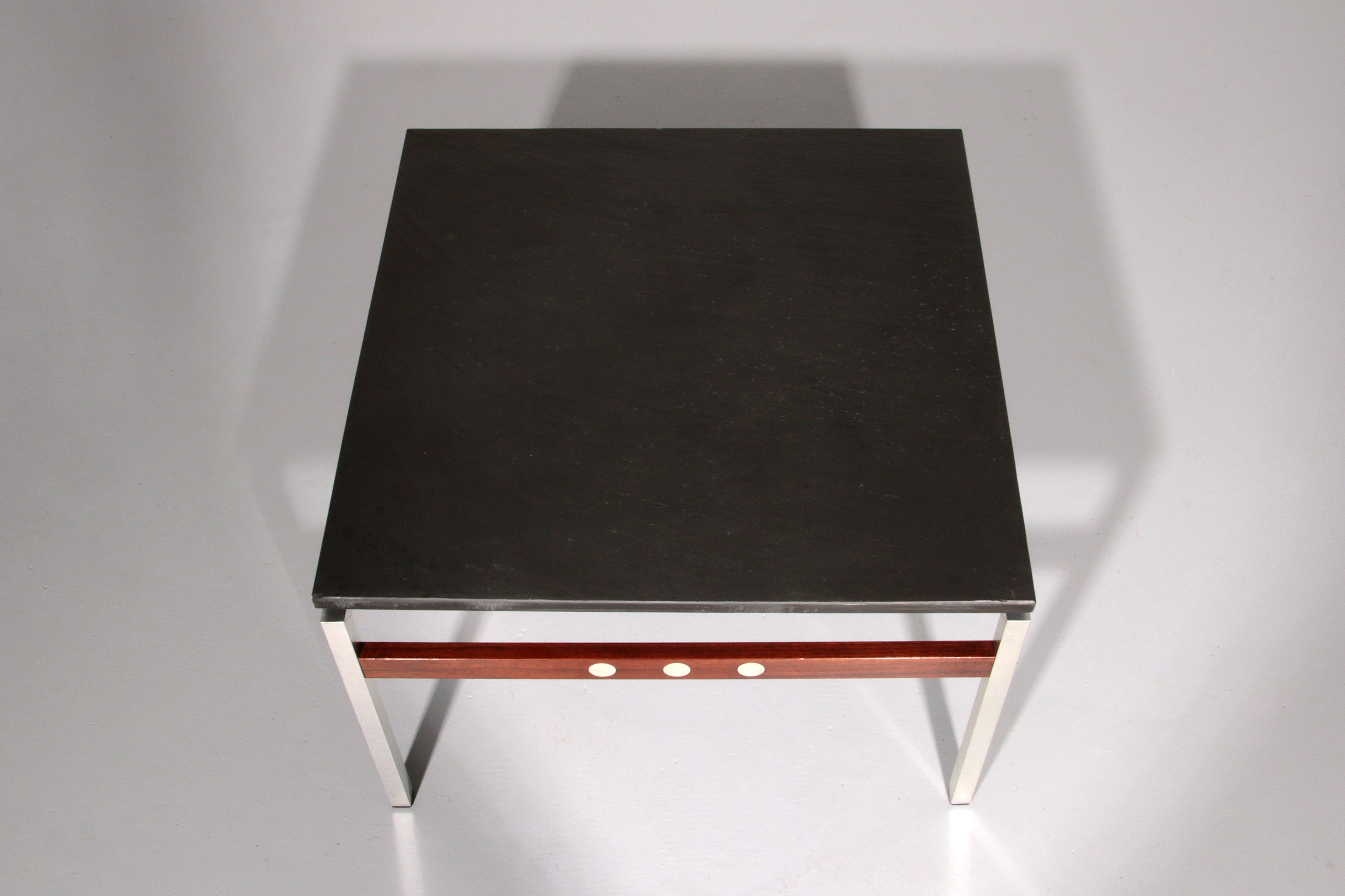 A beautiful and distinctive vintage coffee table, crafted in Denmark in the 1970s. The table combines a natural slate tabletop