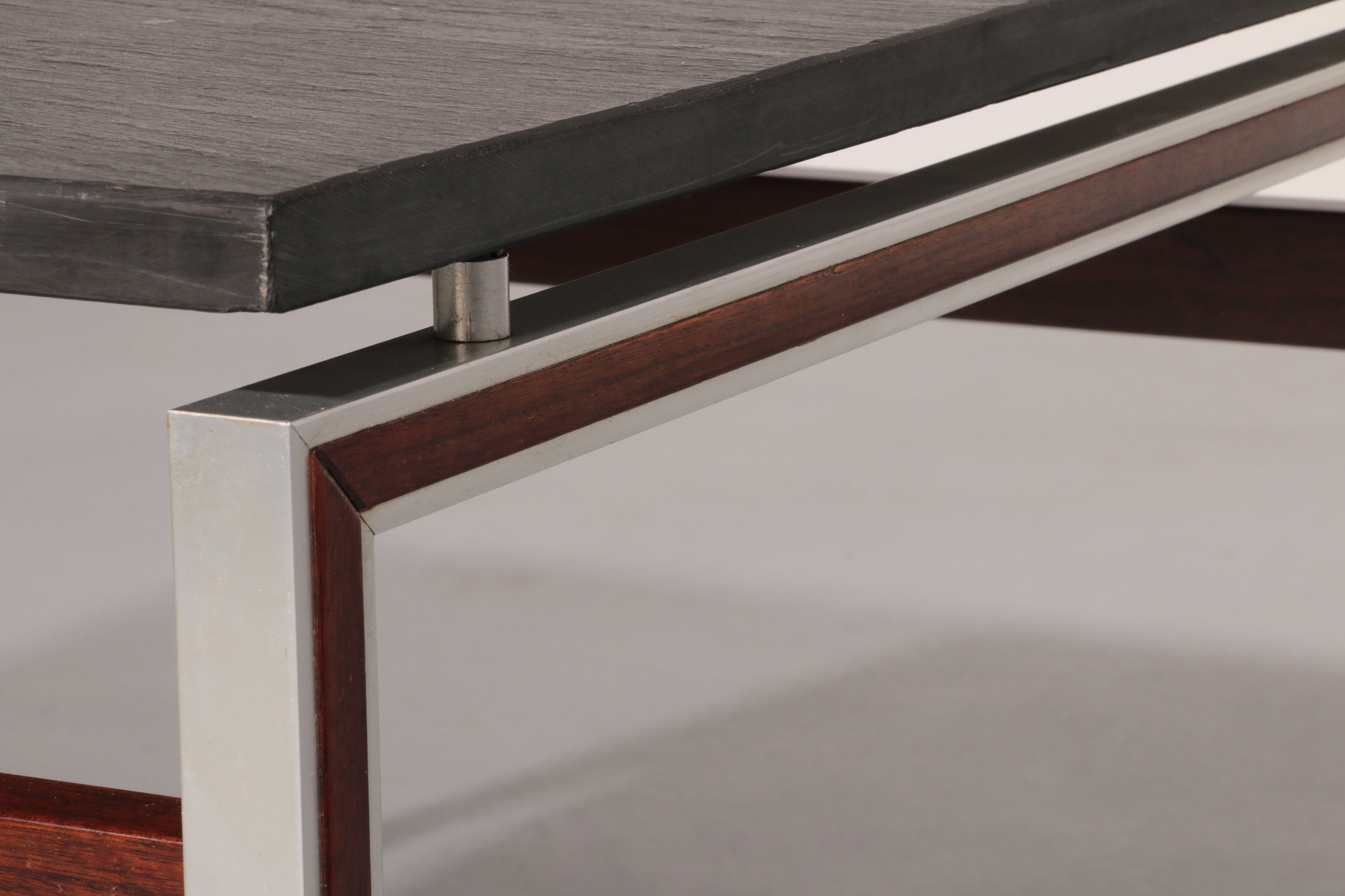 A beautiful and distinctive vintage coffee table, crafted in Denmark in the 1970s. The table combines a natural slate tabletop