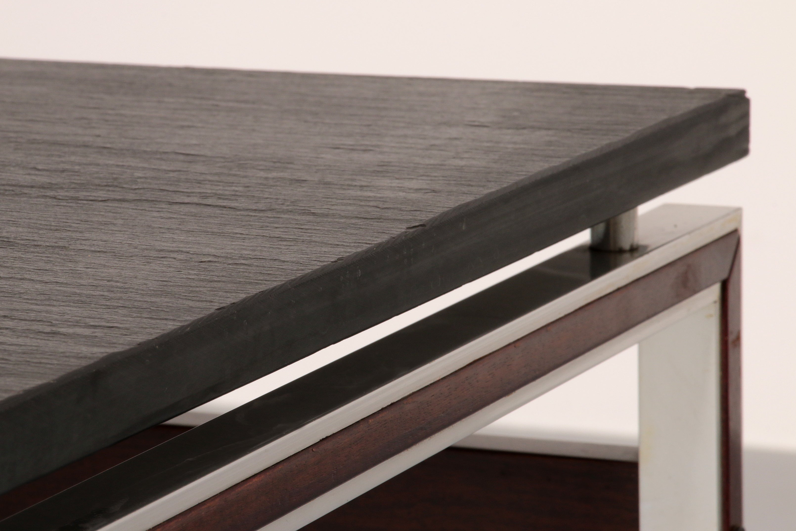 A beautiful and distinctive vintage coffee table, crafted in Denmark in the 1970s. The table combines a natural slate tabletop