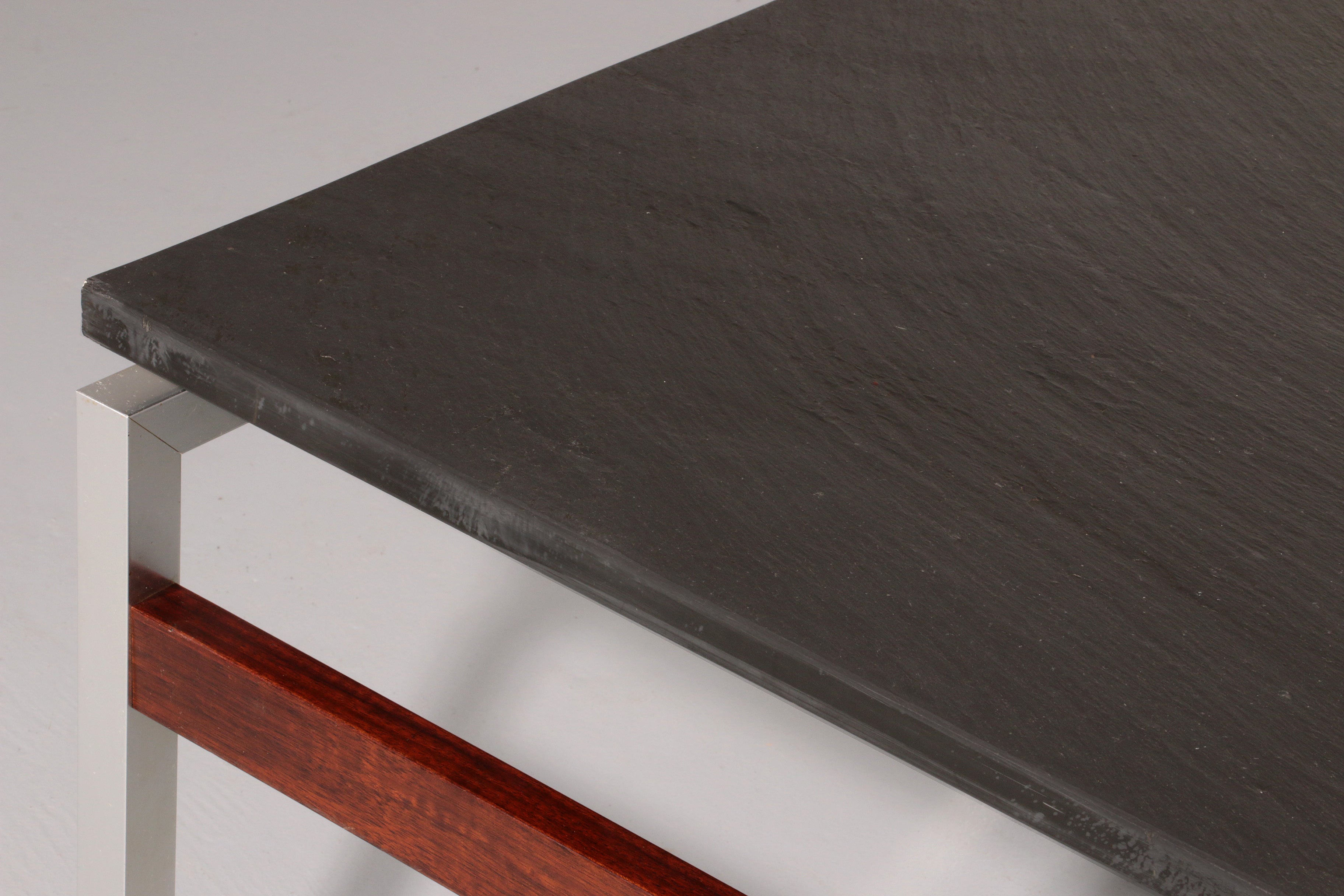 A beautiful and distinctive vintage coffee table, crafted in Denmark in the 1970s. The table combines a natural slate tabletop