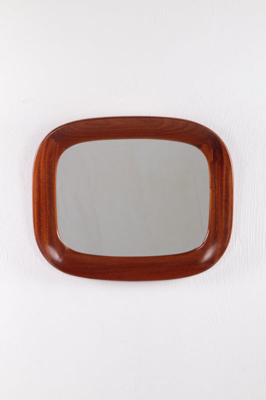 Vintage mirror with wide wooden edge.