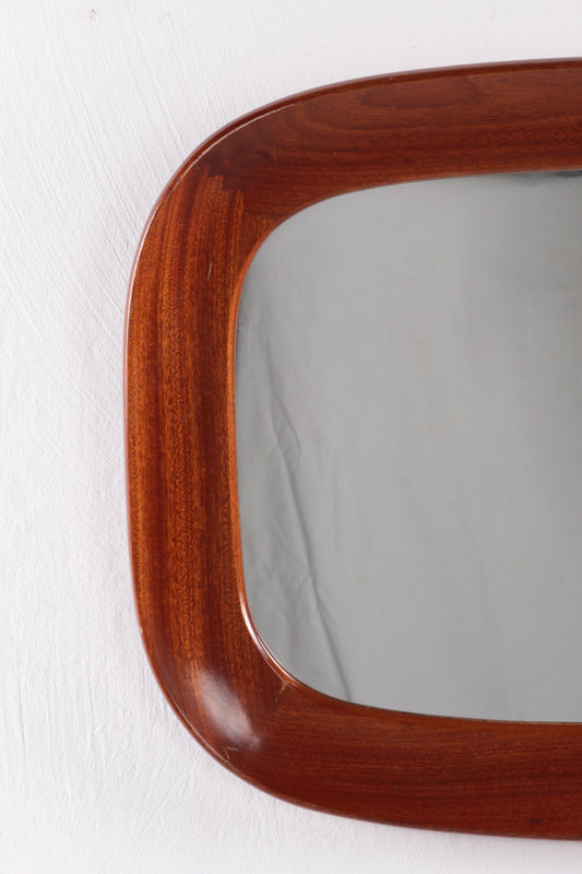Vintage mirror with wide wooden edge.