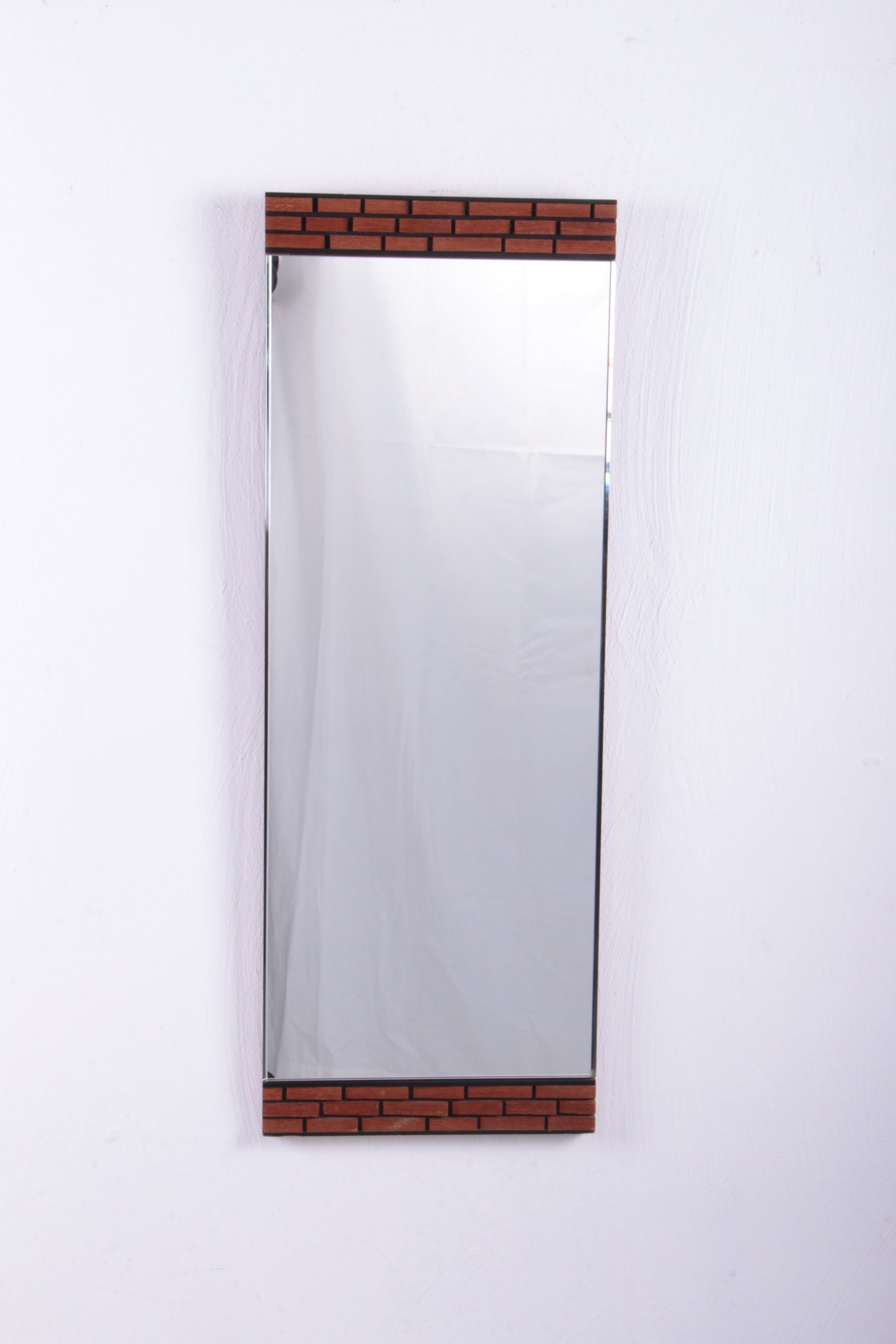 Oblong wall mirror with block pattern