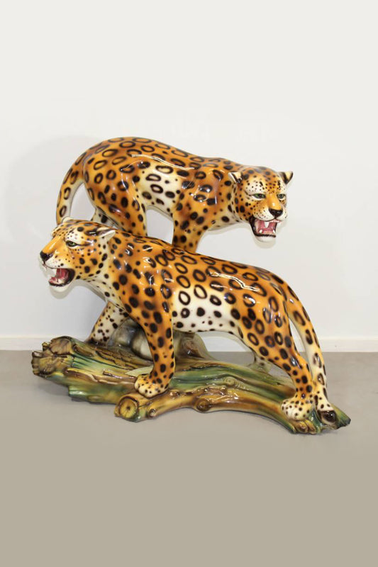 Ceramic panthers on tree trunk
