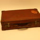 Old leather English suitcase with sticker