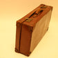 Old leather English suitcase with sticker